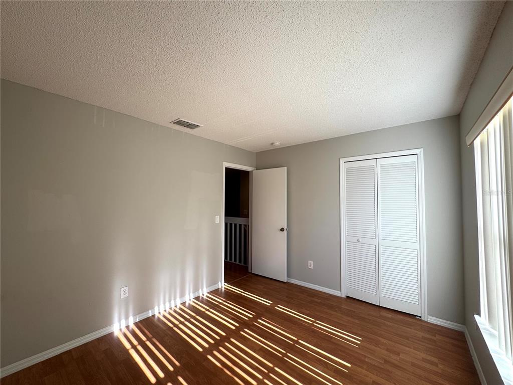 14328 Rainsong Drive Orlando, FL 32824 - Photo 17 of 27 a view of a room with wooden floor