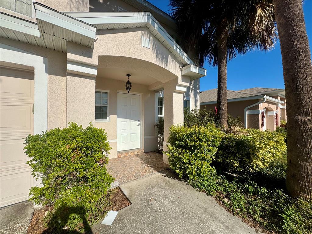 14328 Rainsong Drive Orlando, FL 32824 - Photo 2 of 27 a front view of a house with a yard