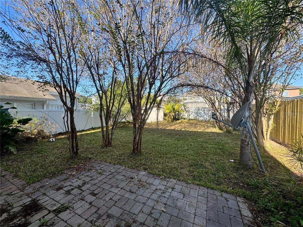 14328 Rainsong Drive Orlando, FL 32824 - Photo 27 of 27 a view of a yard with plants and trees