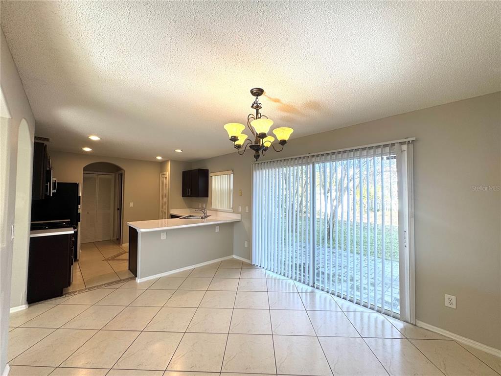 14328 Rainsong Drive Orlando, FL 32824 - Photo 8 of 27 a view of kitchen with granite countertop cabinets and window