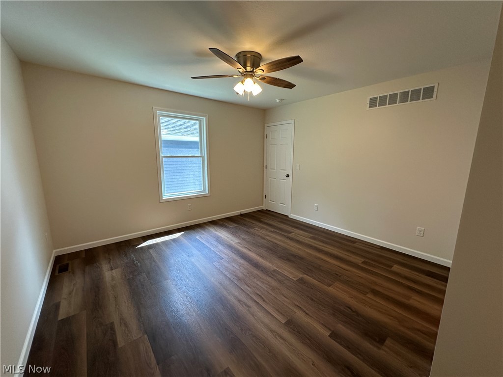 78 Prospect Street Struthers, OH 44471 - Photo 9 of 17 LTV flooring, ceiling fan with integrated lighting, single window, neutral wall tones, and white trim throughout