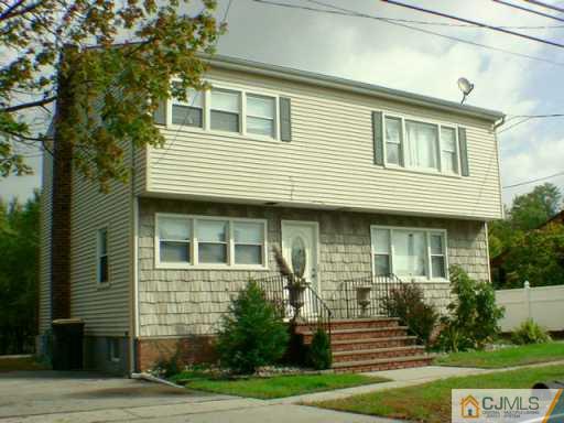 46 Amboy Road Old Bridge, NJ 07747 - Photo 2 of 3 a front view of a house with garden