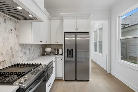 a kitchen with stainless steel appliances granite countertop a stove and a refrigerator