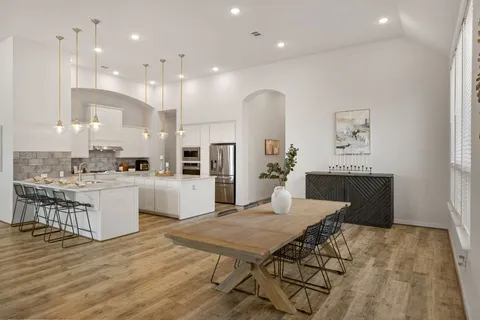 a kitchen with a table and chairs in it