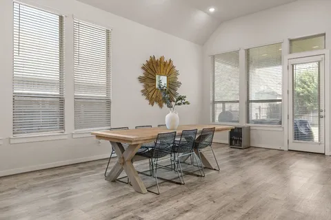 a view of a dining room with furniture and wooden floor