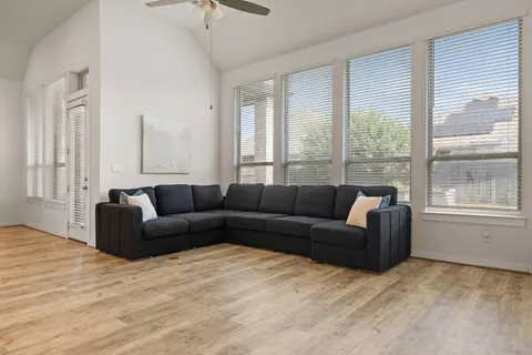 a living room with furniture and a large window