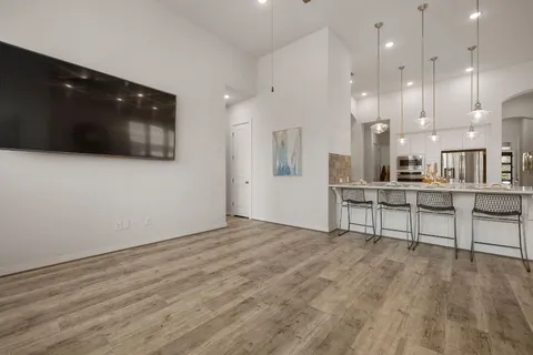 a view of kitchen with refrigerator and wooden floor