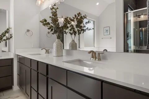 a bathroom with a double vanity sink and a mirror