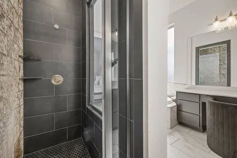 a bathroom with a sink toilet and shower