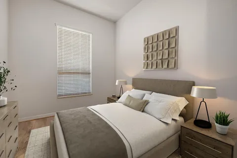 a bedroom with a bed and a window