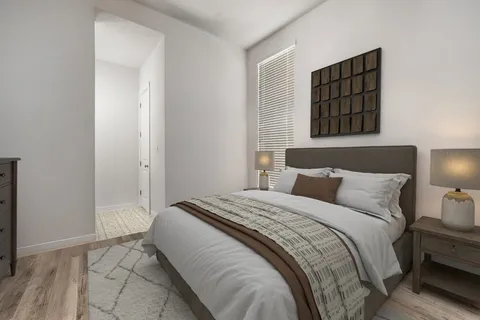 a spacious bedroom with a bed and a window
