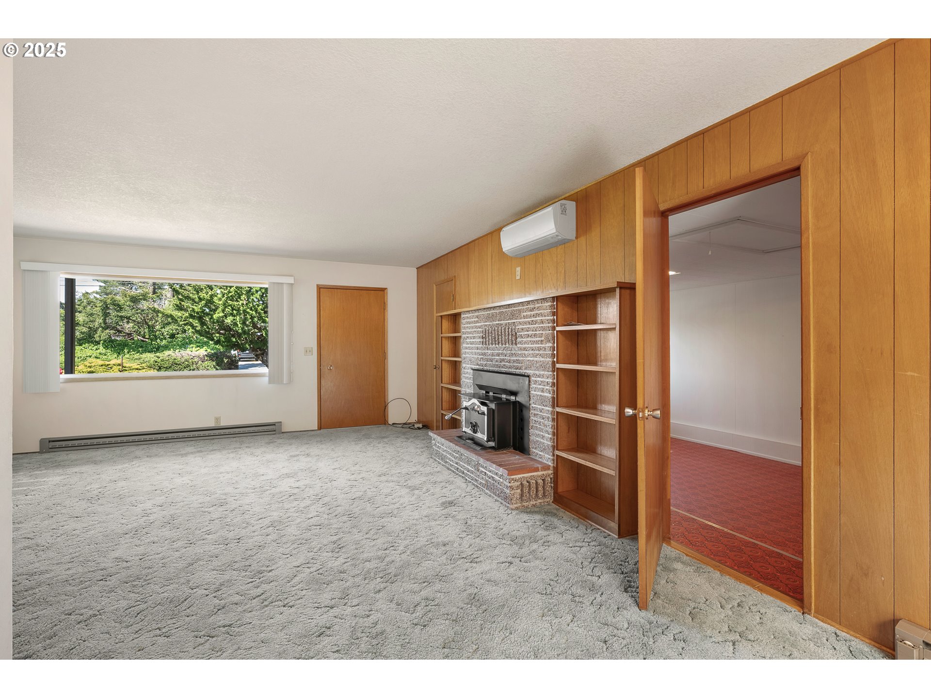 1088 Nopal Street Florence, OR 97439 - Photo 18 of 37 view of an empty room with a fireplace and a window