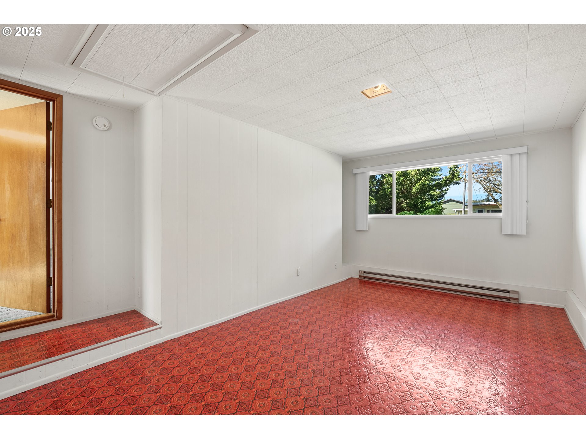 1088 Nopal Street Florence, OR 97439 - Photo 19 of 37 a view of an empty room with wooden floor and a window
