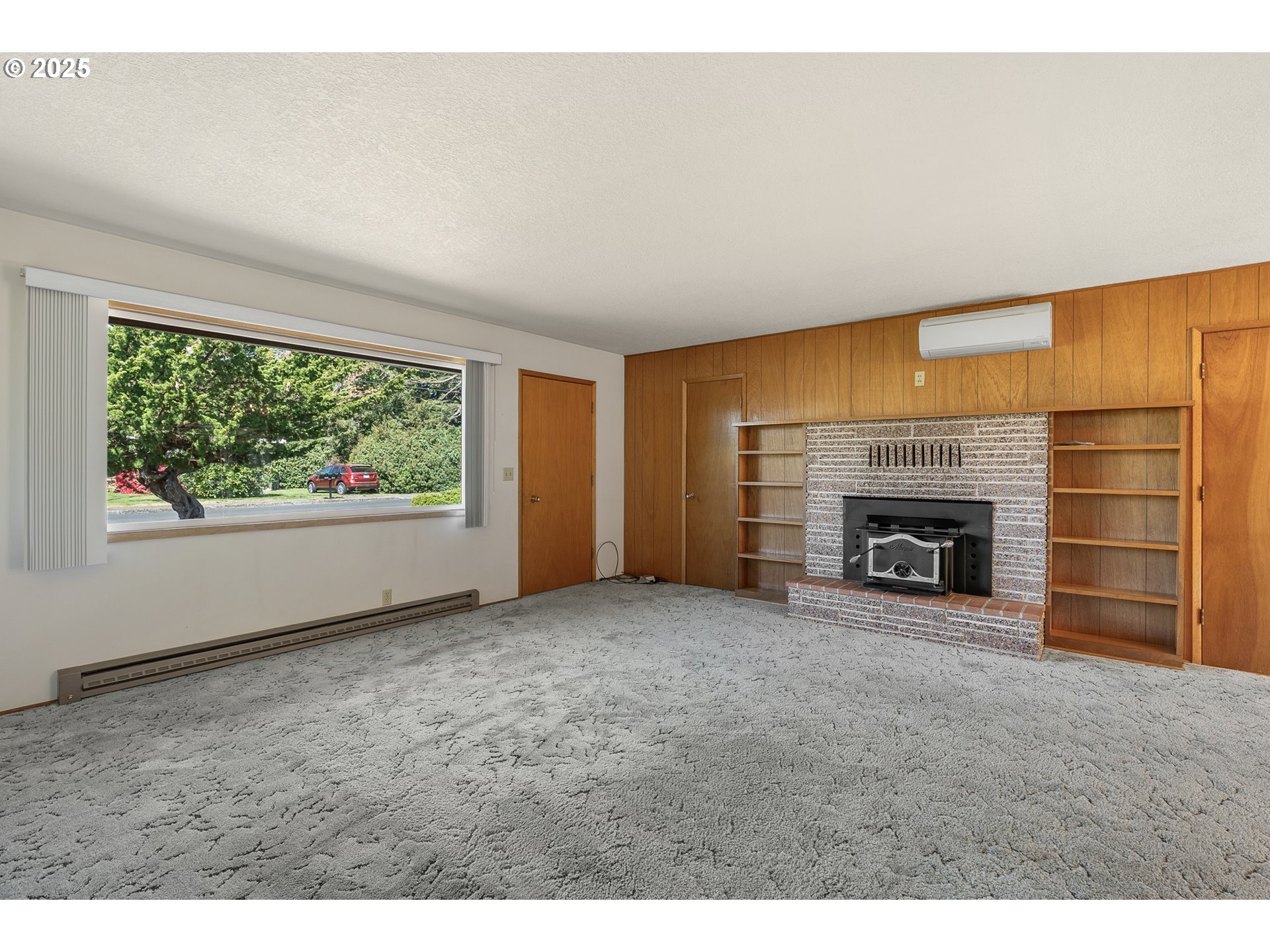1088 Nopal Street Florence, OR 97439 - Photo 9 of 37 a view of an empty room with a fireplace and a window