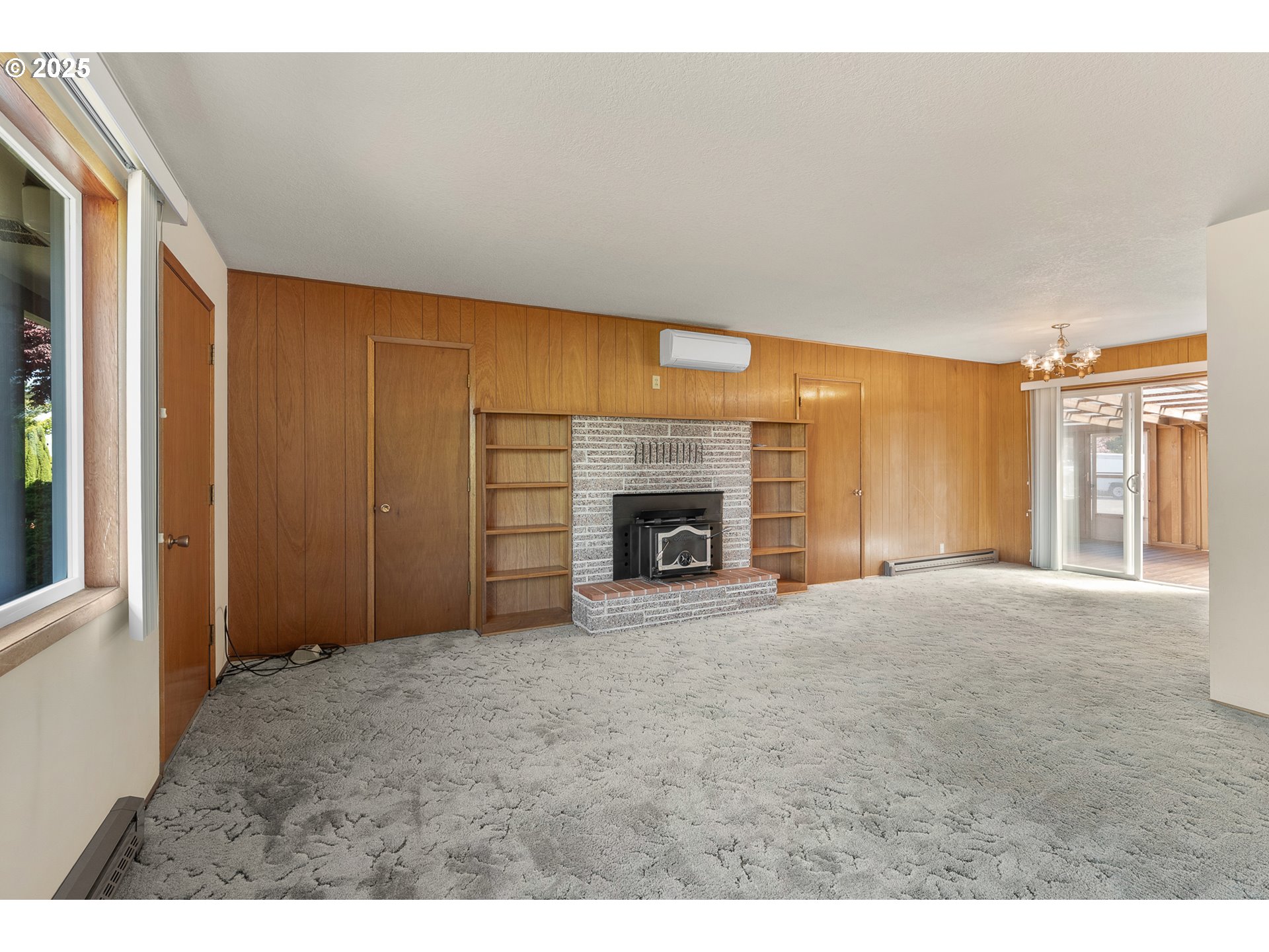 1088 Nopal Street Florence, OR 97439 - Photo 10 of 37 a view of an empty room with a fireplace and a window