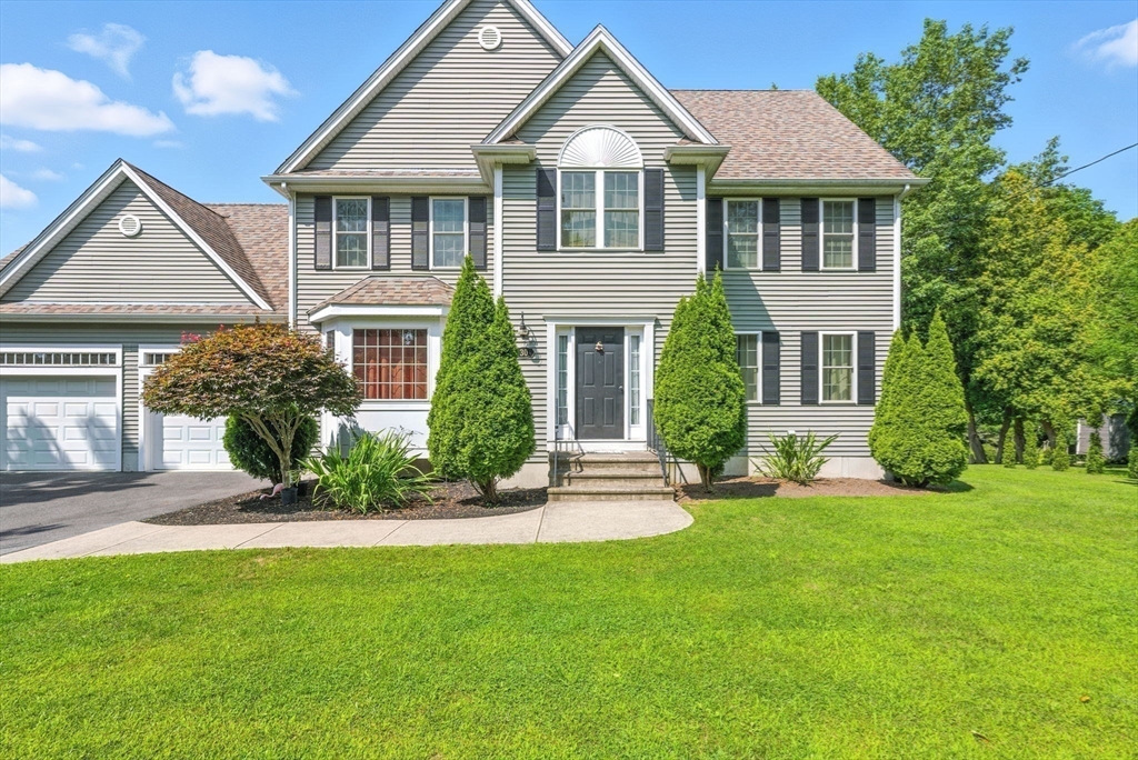 30 Neponset Street Walpole, MA 02071 - Photo 32 of 41 a front view of a house with a yard and potted plants