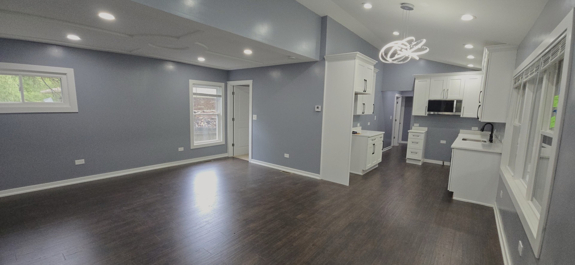 15407 Kenton Avenue Oak Forest, IL 60452 - Photo 3 of 20 an empty room with wooden floor and a kitchen