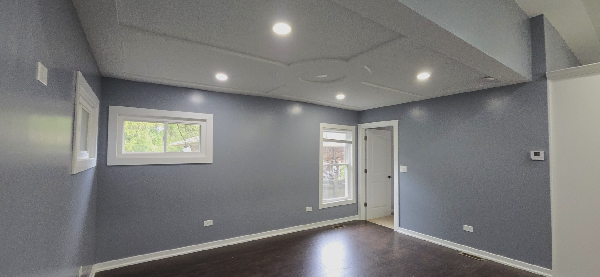 15407 Kenton Avenue Oak Forest, IL 60452 - Photo 4 of 20 an empty room with wooden floor and windows with curtains