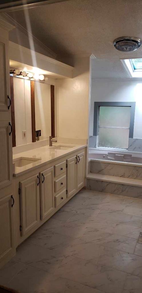 125 Sputnik Street Fortson, GA 31808 - Photo 20 of 30 a bathroom with a double vanity sink and mirror