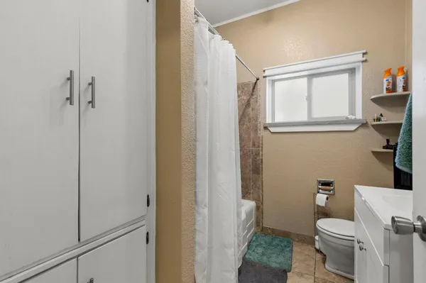 a white toilet sitting next to a bathroom sink