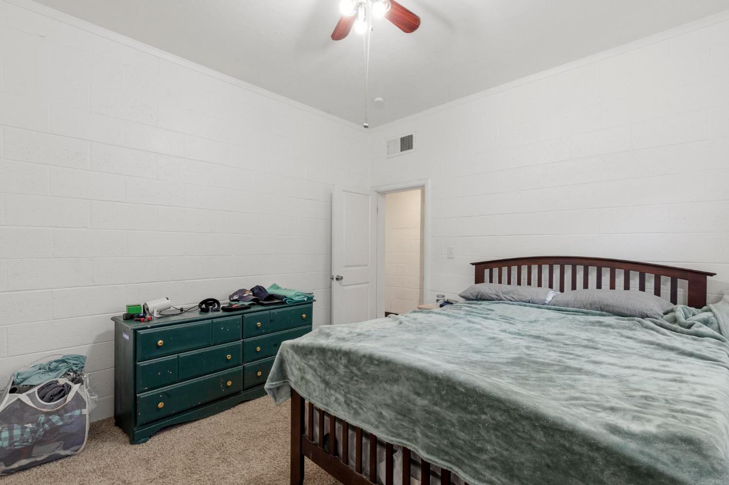 724 Webster Street Colusa, CA 95932 - Photo 19 of 48 a bedroom with a bed and a chandelier