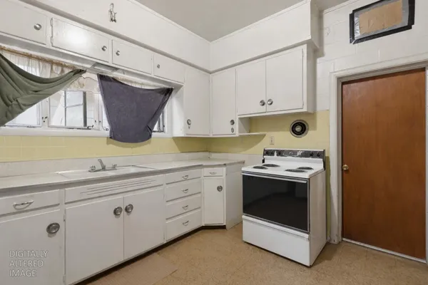 a kitchen with granite countertop cabinets appliances a sink and a window