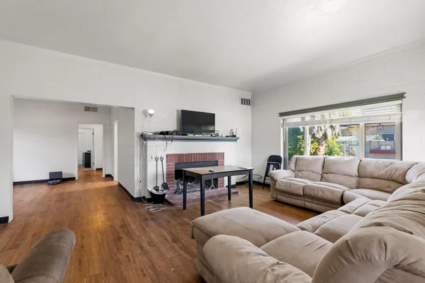 a living room with furniture flat screen tv and a fireplace