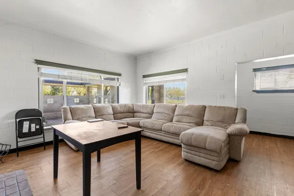 a living room with furniture and a wooden floor