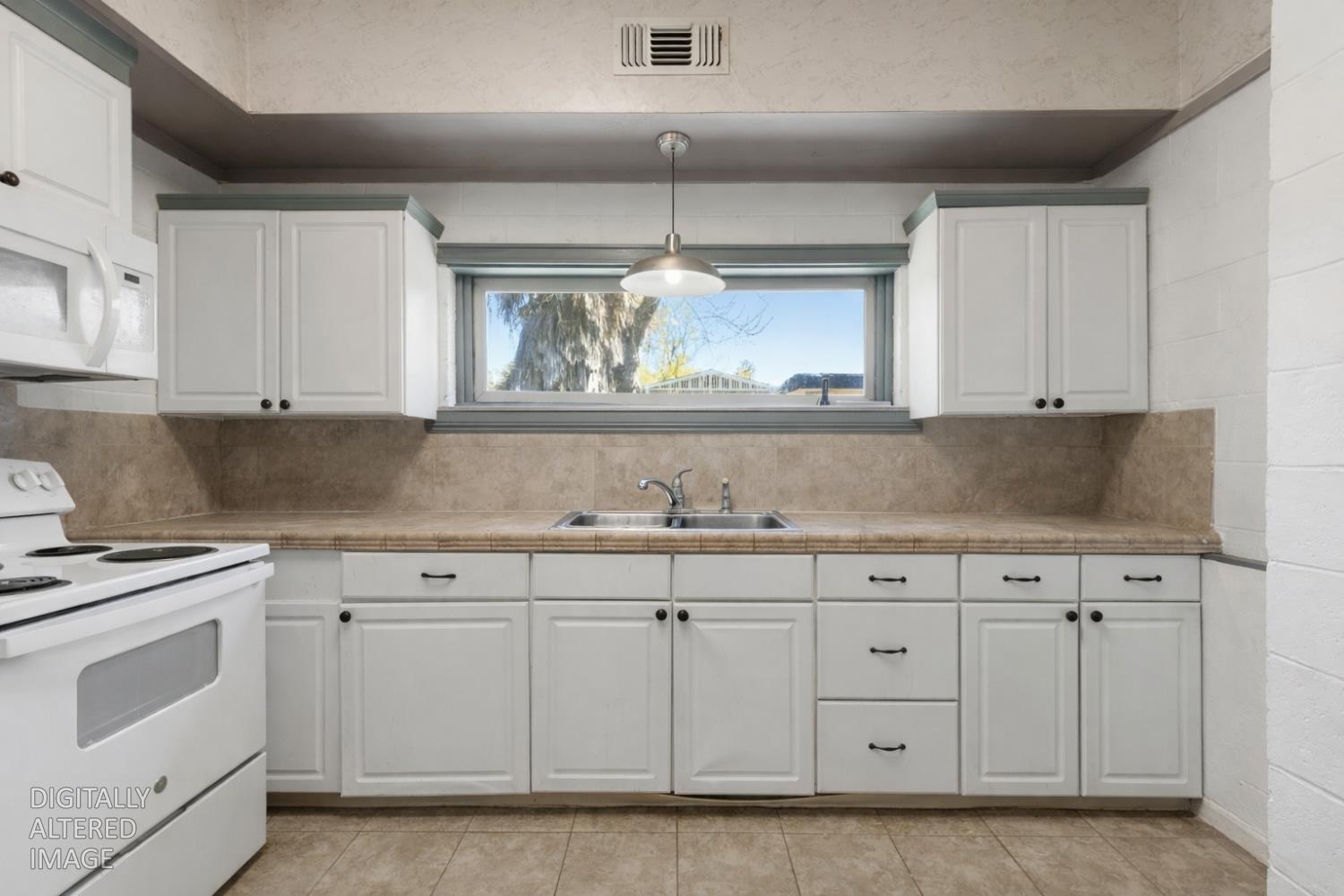 724 Webster Street Colusa, CA 95932 - Photo 9 of 48 a kitchen with white cabinets and white appliances