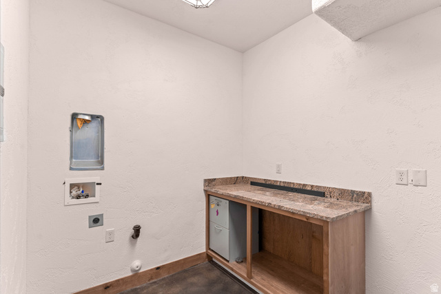 2464 East Granite Way St. George, UT 84790 - Photo 91 of 106 Laundry room featuring a textured wall, gas dryer hookup, washer hookup, finished concrete flooring, and electric dryer hookup