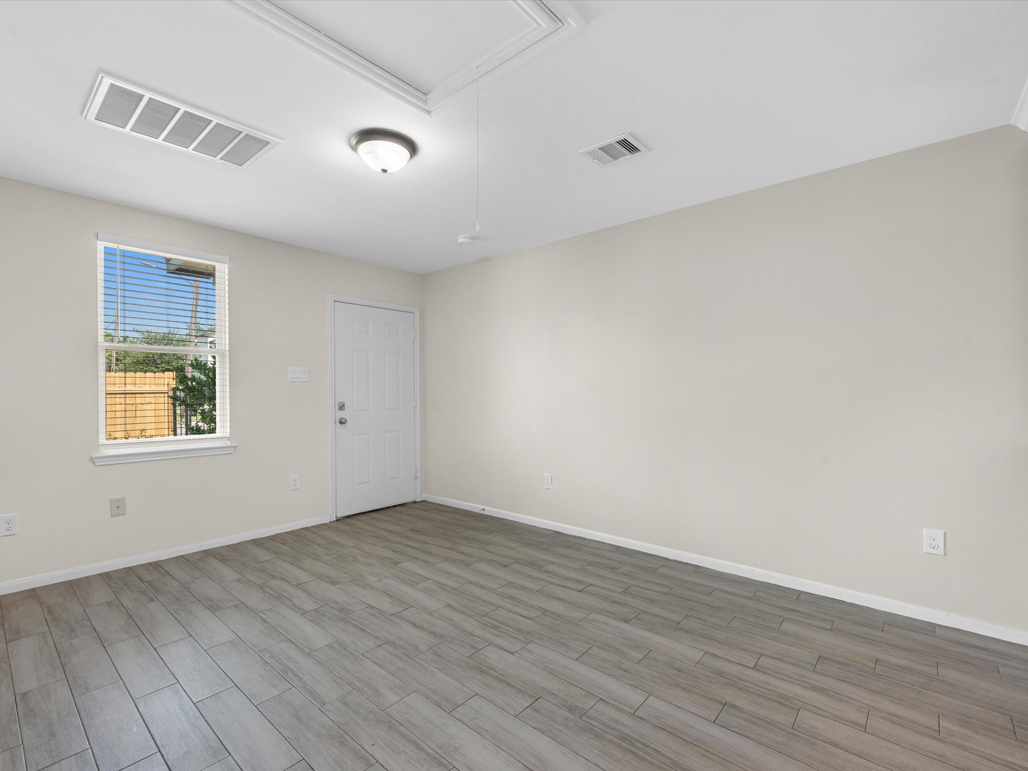 2202 Solo Street, Unit 2204 Houston, TX 77020 - Photo 8 of 21 a view of an empty room with wooden floor and a window