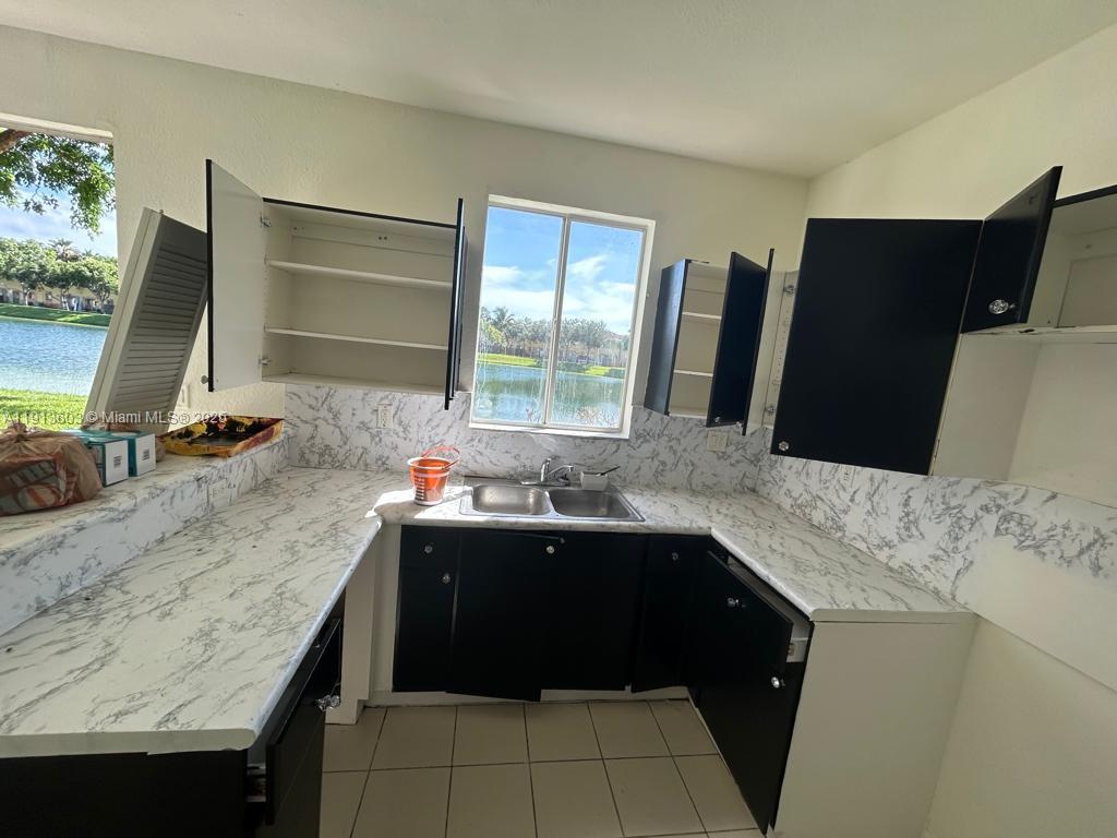 2851 Southeast 15th Road, Unit 78 Homestead, FL 33035 - Photo 4 of 6 a kitchen with a sink and a refrigerator