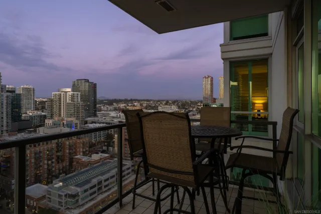 a view of a patio with table and chairs potted plants and a large tree