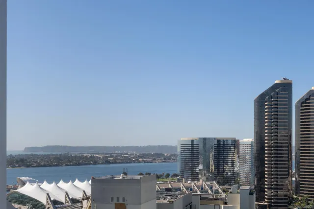 a view of a patio with couches and table and chairs and potted plants