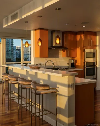 a view of a livingroom with furniture a flat screen tv and floor to ceiling window