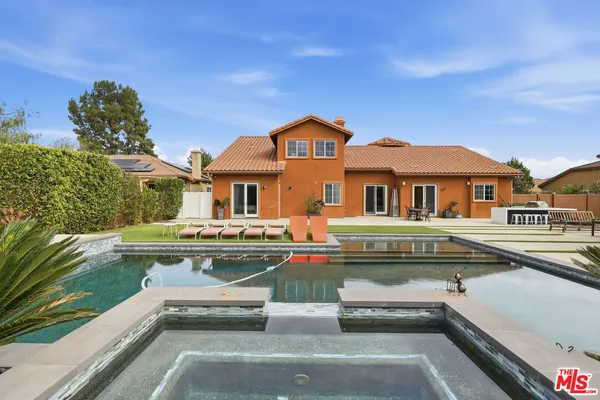 a view of house with swimming pool outdoor seating