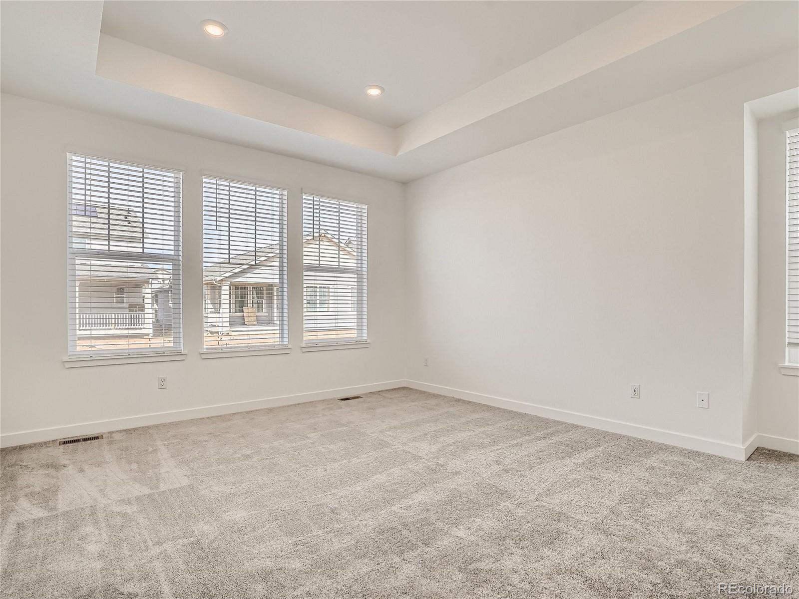 9975 Uvalda Street Commerce City, CO 80022 - Photo 14 of 29 an empty room with windows