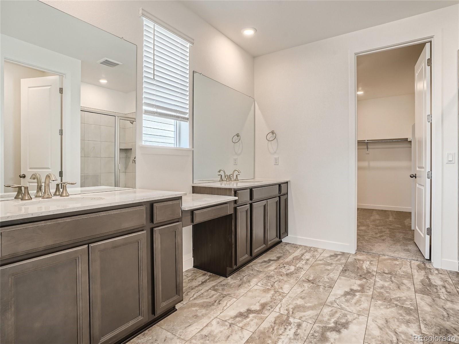 9975 Uvalda Street Commerce City, CO 80022 - Photo 16 of 29 a bathroom with a sink and a mirror