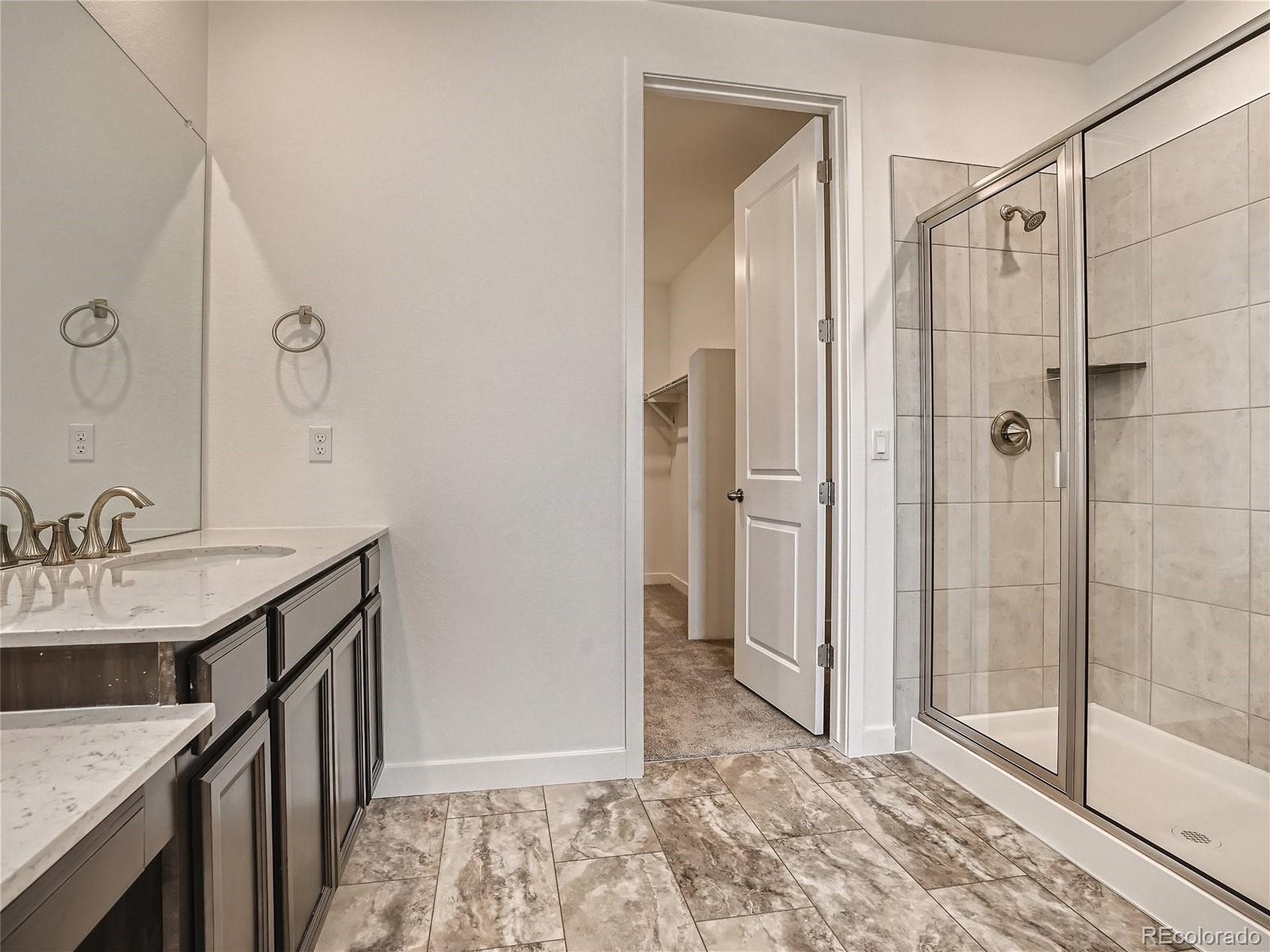 9975 Uvalda Street Commerce City, CO 80022 - Photo 17 of 29 a bathroom with a sink and a mirror