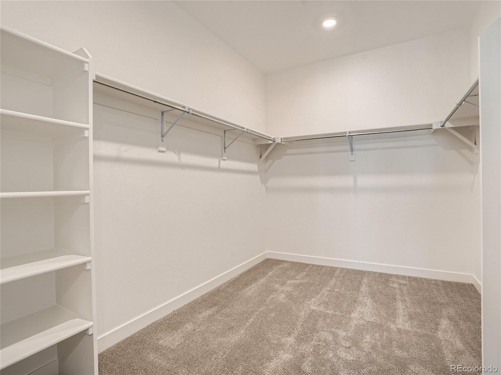 9975 Uvalda Street Commerce City, CO 80022 - Photo 18 of 29 a view of an empty walk in closet