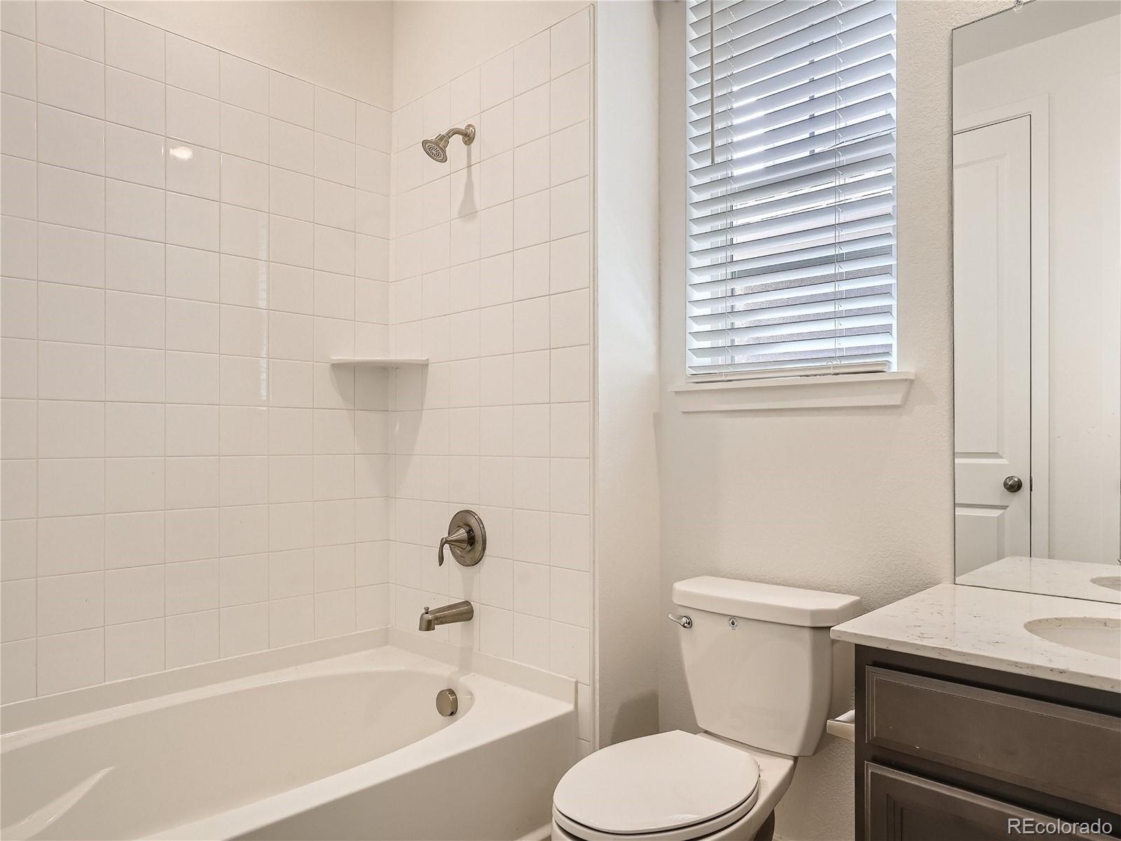 9975 Uvalda Street Commerce City, CO 80022 - Photo 21 of 29 a white toilet sitting next to a bath tub