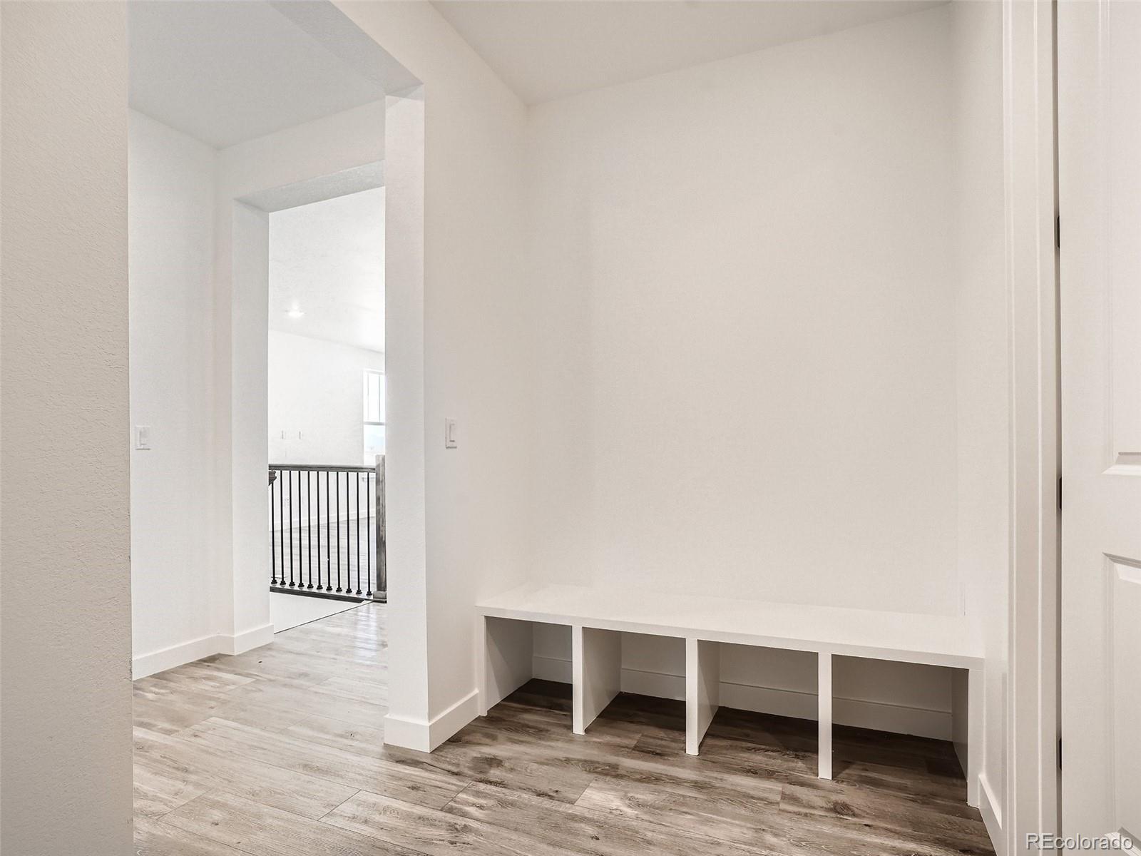 9975 Uvalda Street Commerce City, CO 80022 - Photo 25 of 29 a view of an empty room with wooden floor and a window