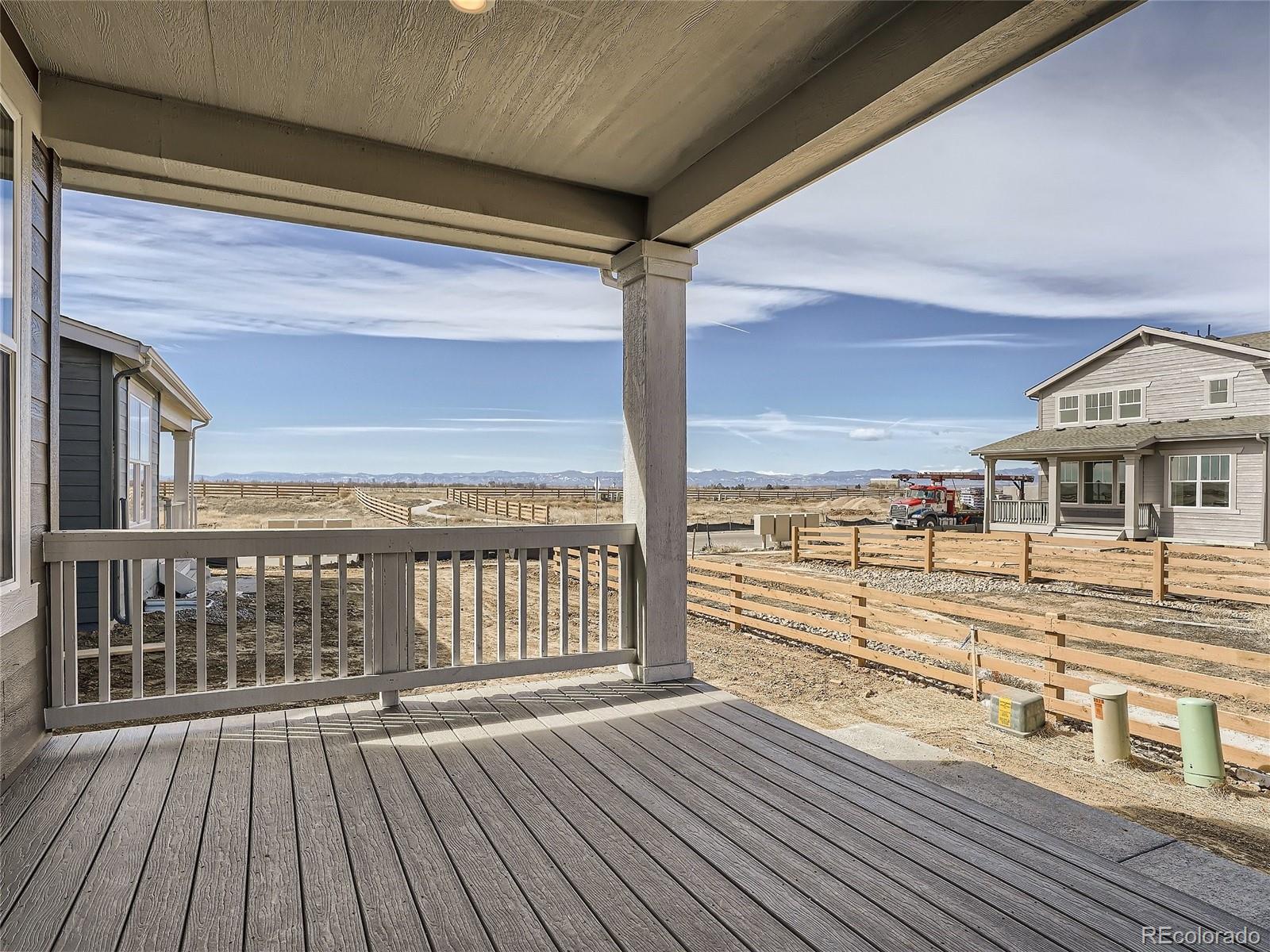 9975 Uvalda Street Commerce City, CO 80022 - Photo 26 of 29 a view of a balcony with wooden floor