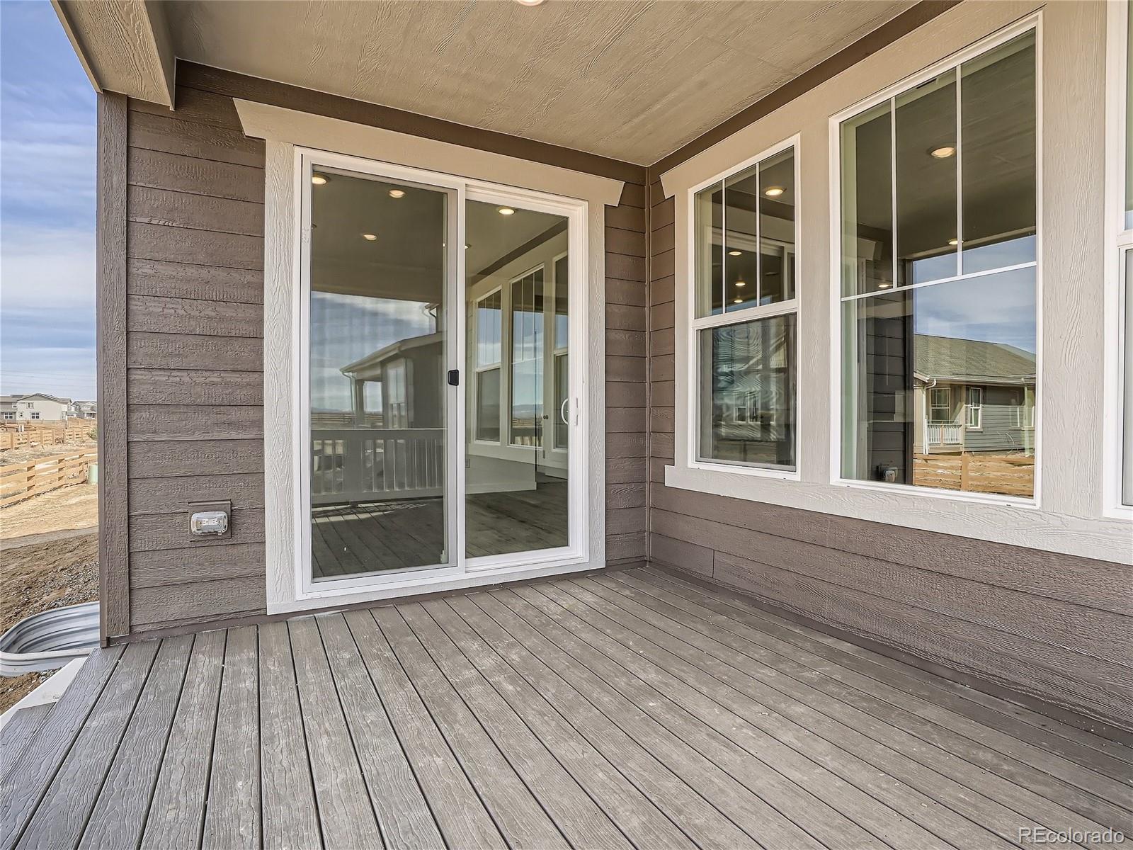 9975 Uvalda Street Commerce City, CO 80022 - Photo 27 of 29 an empty room with wooden floor and windows
