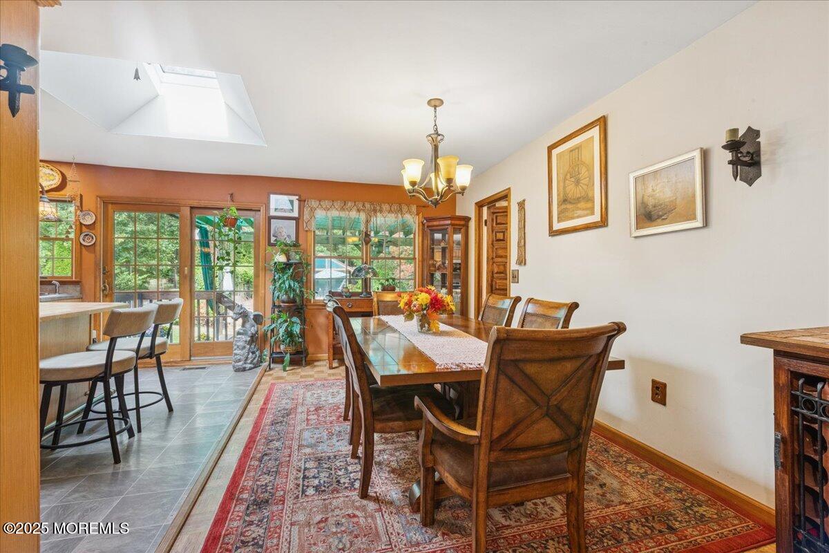 696 Anderson Road Jackson, NJ 08527 - Photo 8 of 34 a dining room with furniture a chandelier and wooden floor