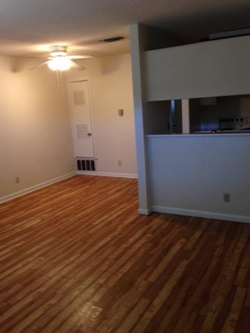 5001 Bull Creek Road, Unit 111 Austin, TX 78731 - Photo 4 of 11 An inviting open-concept area features gleaming hardwood floors and convenient kitchen access.