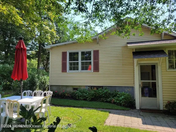 a table and chairs in front of house
