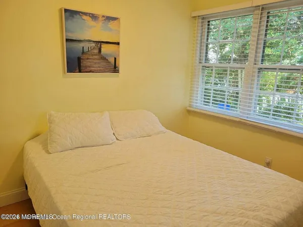 a bed sitting in a bedroom next to a window