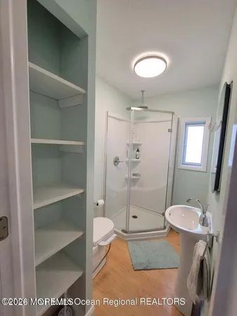 a bathroom with a toilet a sink and shower