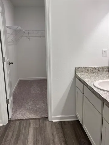 a view of walk in closet with empty racks